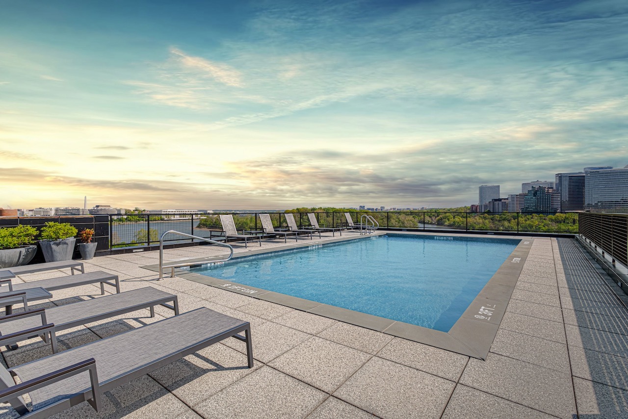 Rooftop pool with lounging chairs nearby